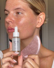 Aima Sense After Sex intimolja hålls mot kind med gua sha-sten